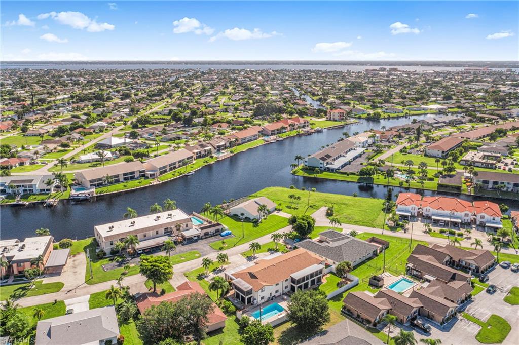 Aerial perspective of suburban area with a large body of water