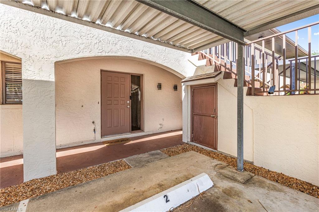 Entrance to property featuring stucco siding