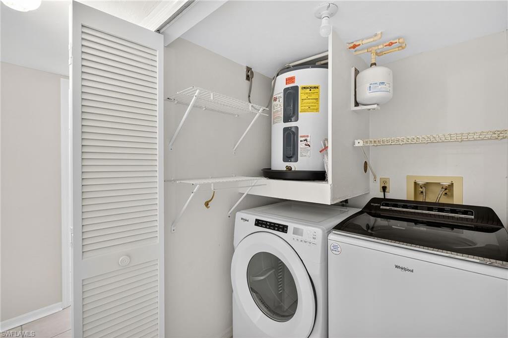 Laundry area with electric water heater and independent washer and dryer