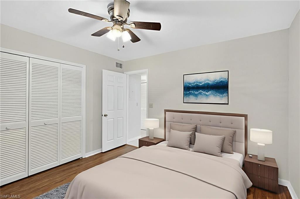 Bedroom featuring dark wood finished floors, a closet, and a ceiling fan