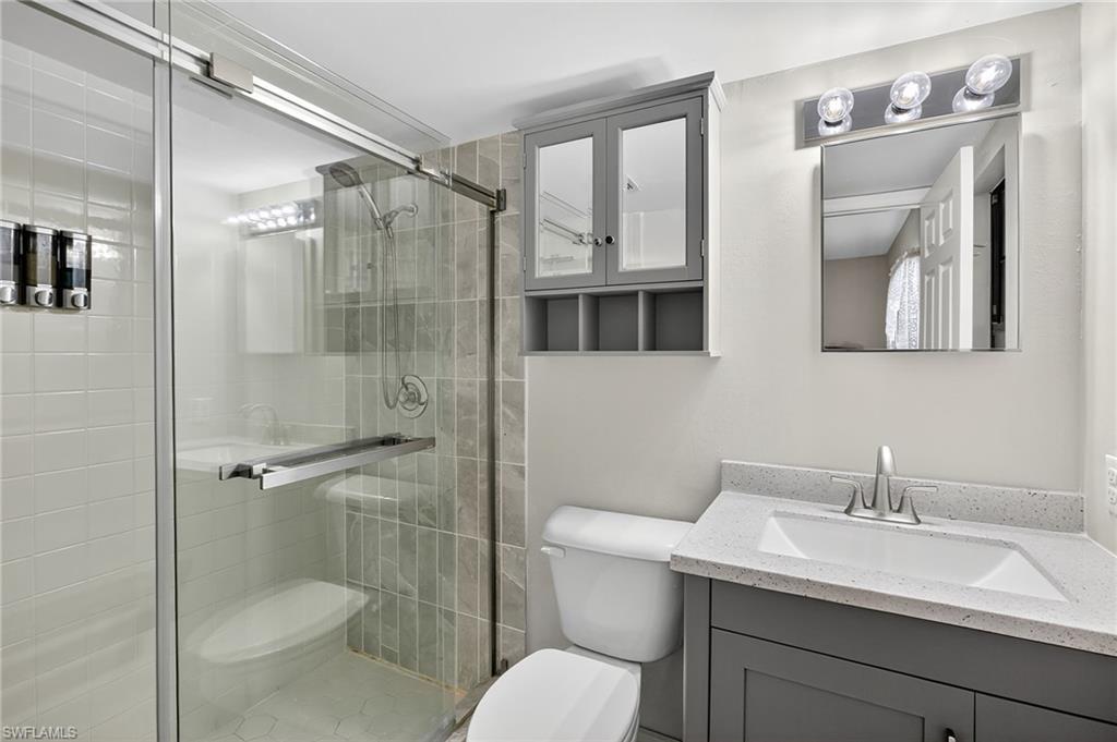 Bathroom featuring a stall shower and vanity