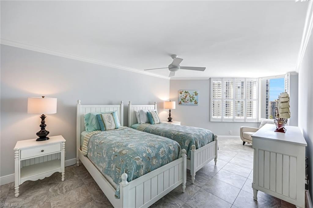 Bedroom featuring crown molding and a ceiling fan