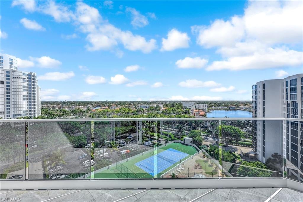 Balcony featuring a water view and a city view