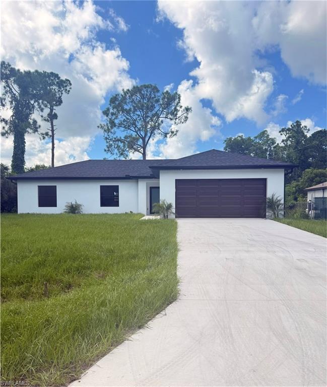 Ranch-style home with stucco siding, concrete driveway, and an attached garage