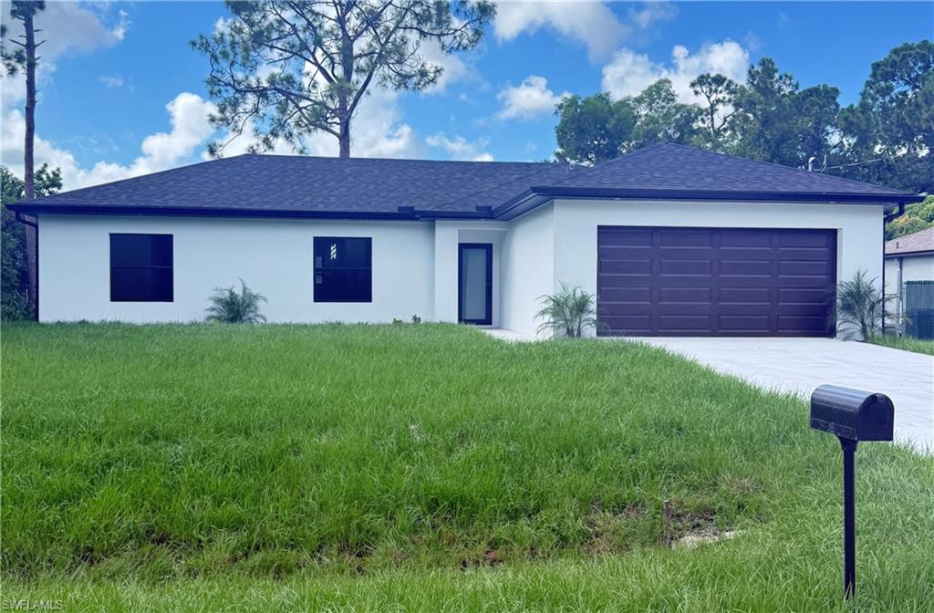 Ranch-style home with roof with shingles, concrete driveway, and stucco siding