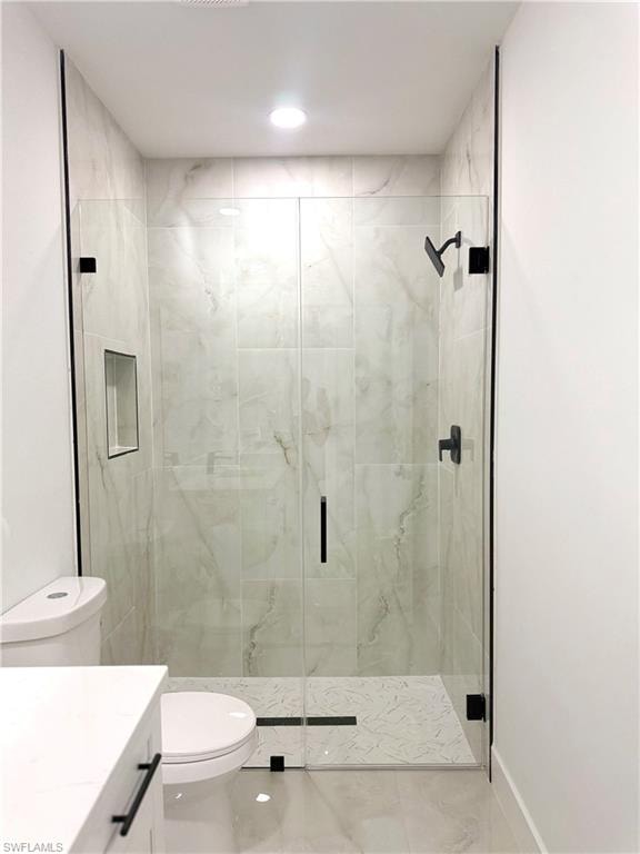 Full bath with vanity, a marble finish shower, and tile patterned floors