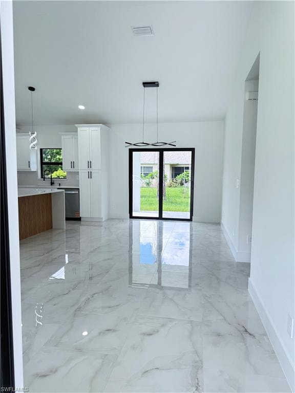 Unfurnished room with light marble finish floors and recessed lighting