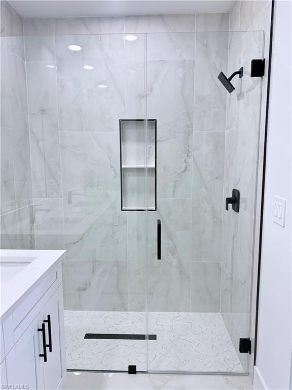 Full bathroom featuring a stall shower and vanity