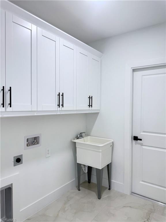 Washroom featuring cabinet space, hookup for a washing machine, and hookup for an electric dryer