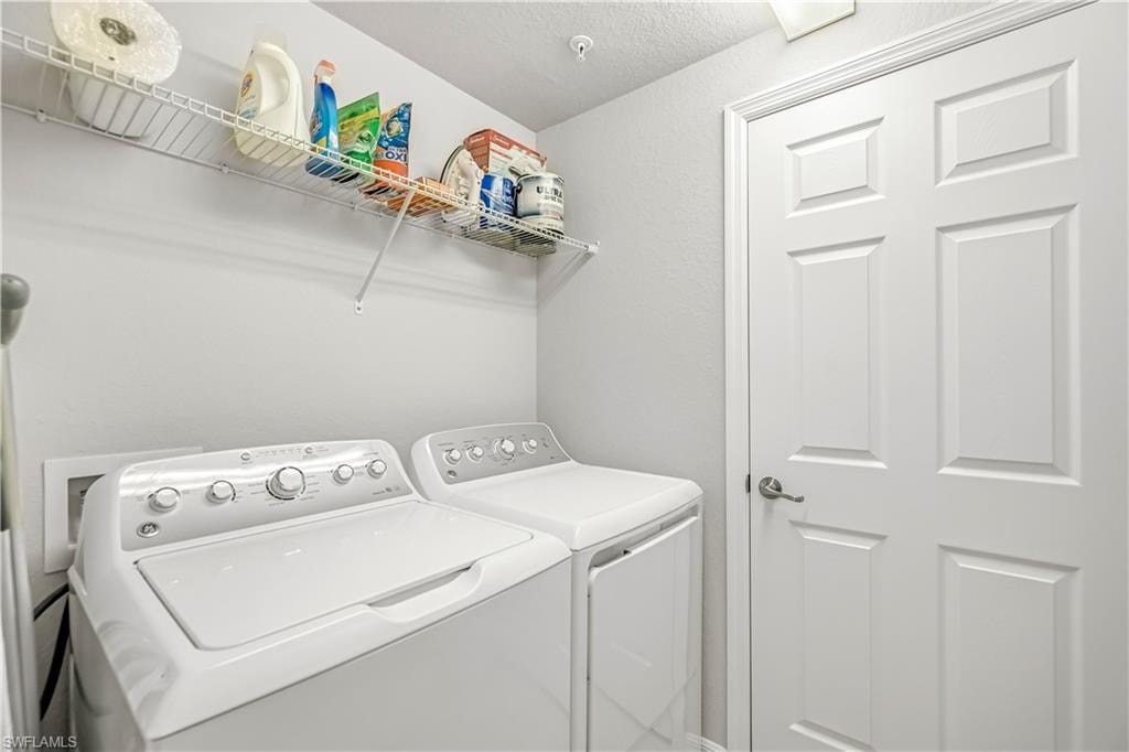 Washroom featuring washing machine and clothes dryer