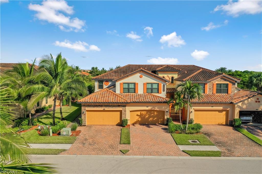 Mediterranean / spanish-style home featuring stucco siding, decorative driveway, a tiled roof, and an attached garage