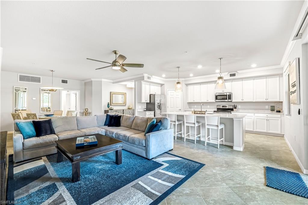 Living room featuring ceiling fan, ornamental molding, and recessed lighting