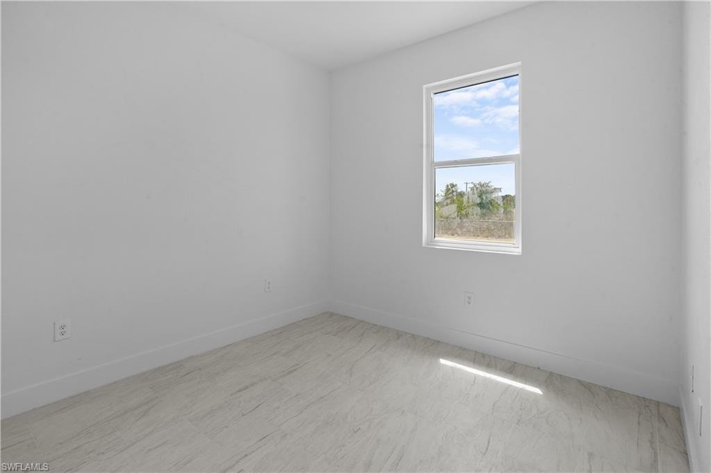 Unfurnished room with baseboards