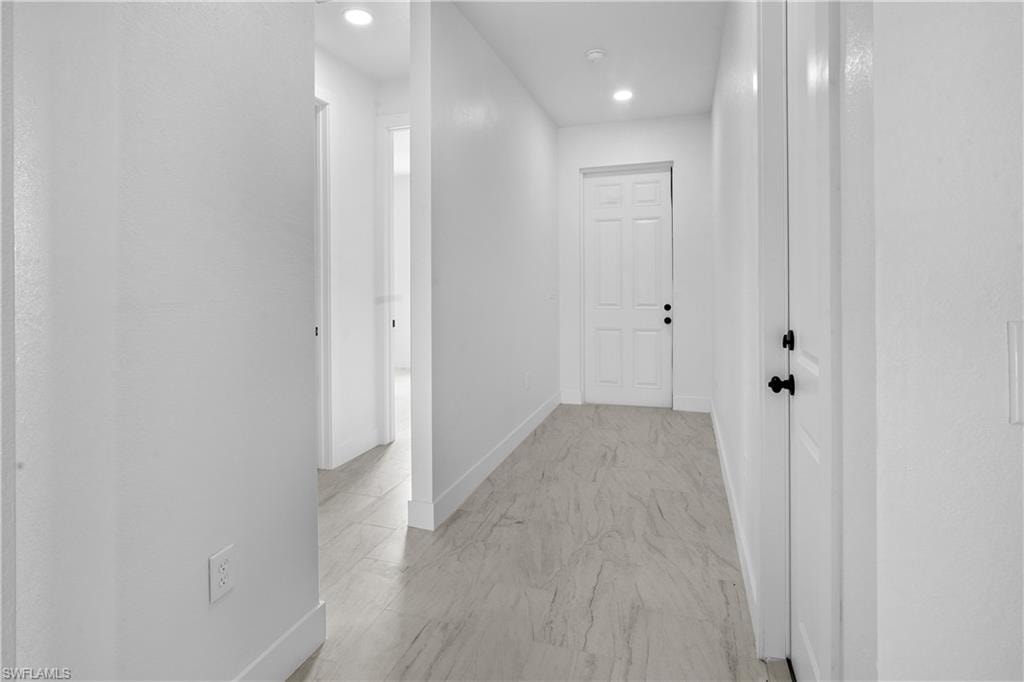 Hall featuring baseboards and recessed lighting