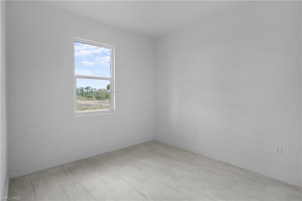 Unfurnished room with baseboards