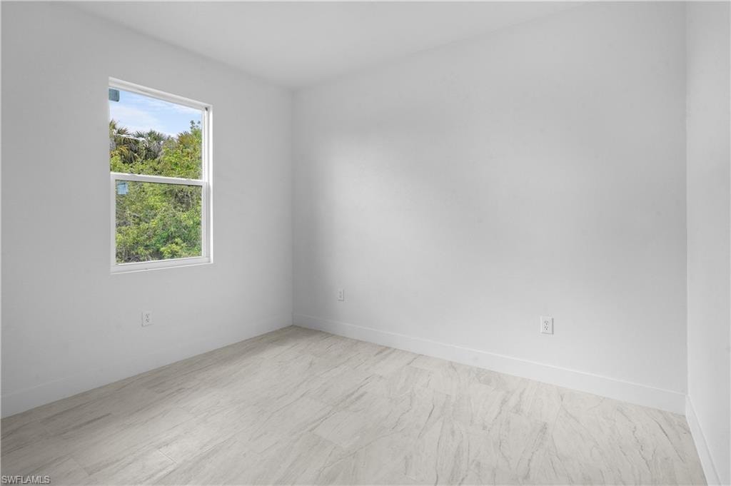 Empty room featuring baseboards
