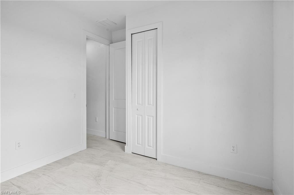 Unfurnished bedroom featuring baseboards and a closet