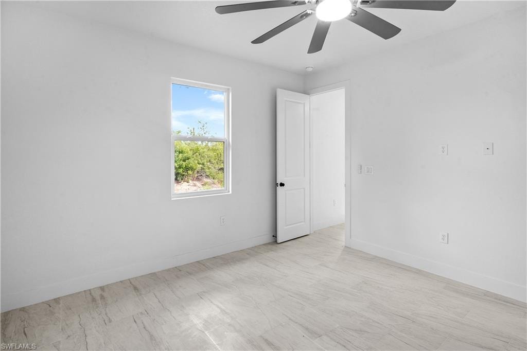 Empty room with light wood-style floors and a ceiling fan