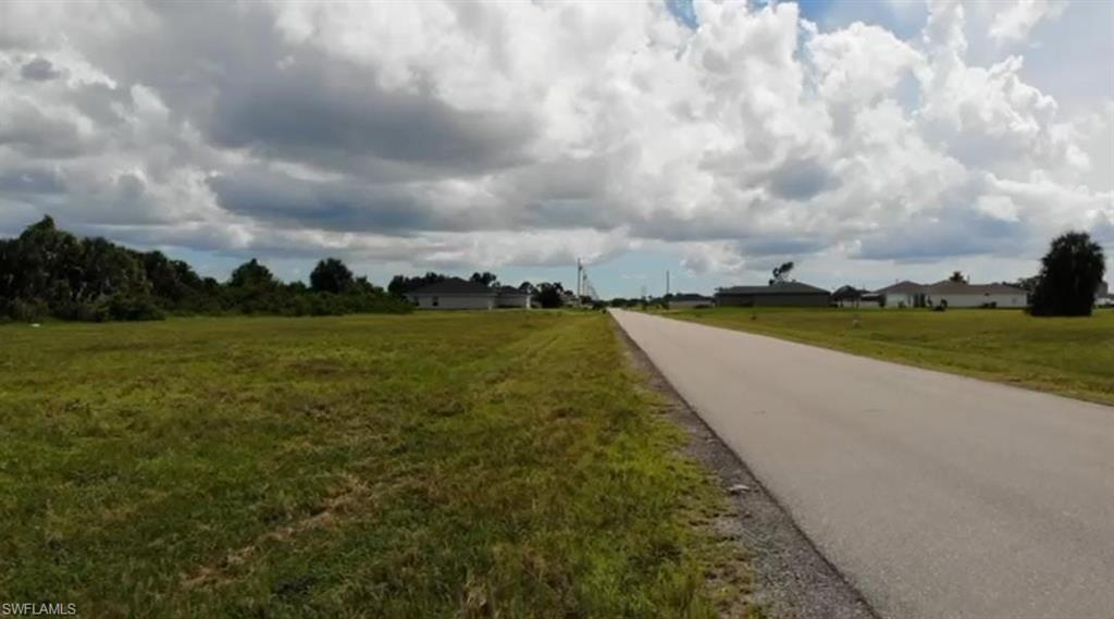 View of asphalt street featuring a view of countryside