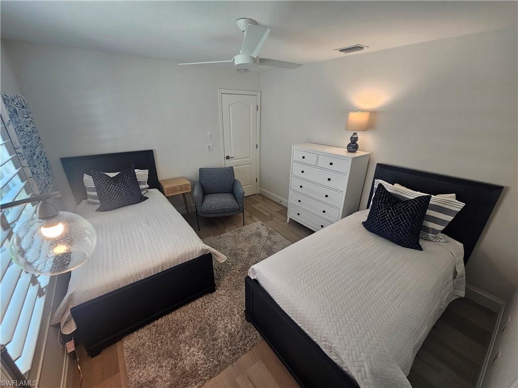 Bedroom featuring hardwood / wood-style flooring and ceiling fan