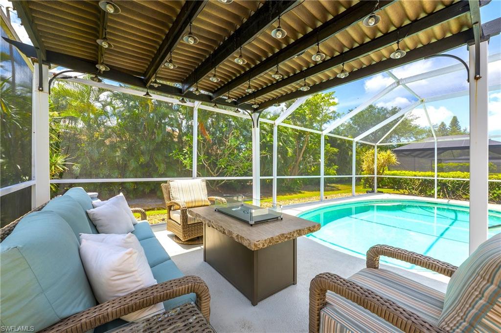 Swimming pool with an outdoor living space, a patio, and glass enclosure