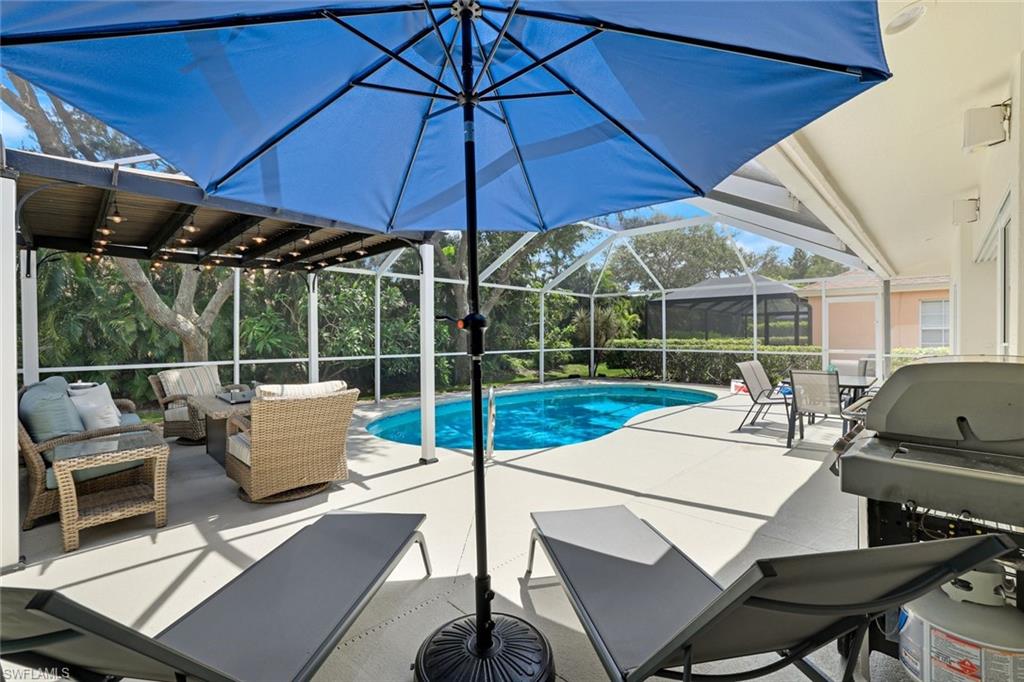 View of swimming pool featuring a patio, a lanai, and grilling area