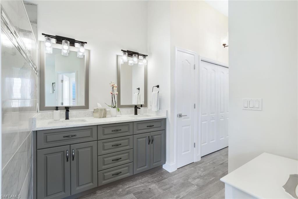 Bathroom featuring double vanity and hardwood / wood-style floors