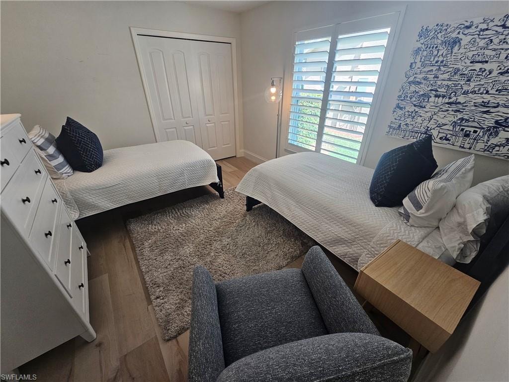 Bedroom with a closet and light hardwood / wood-style flooring