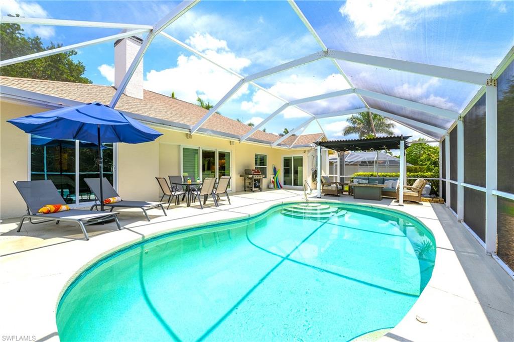 Outdoor pool with an outdoor hangout area, a patio area, grilling area, outdoor dining area, and a lanai