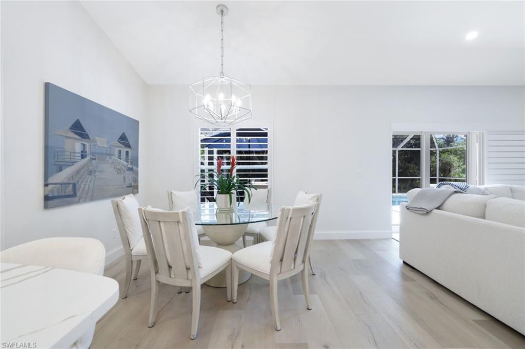 Dining room featuring an inviting chandelier and light wood-type flooring