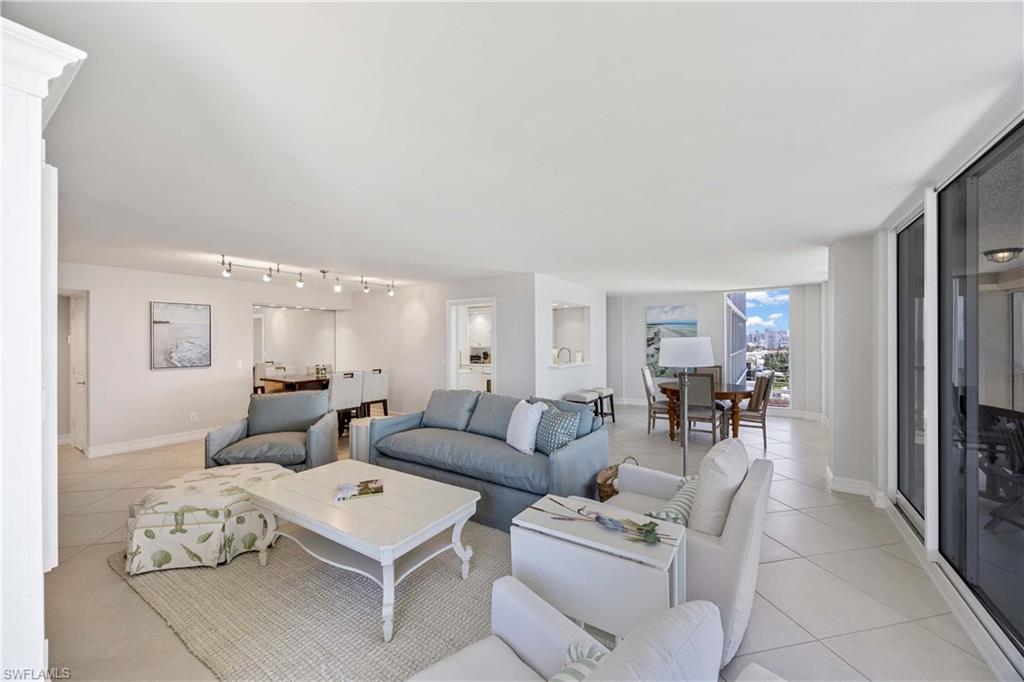 Living room featuring light tile patterned floors and track lighting