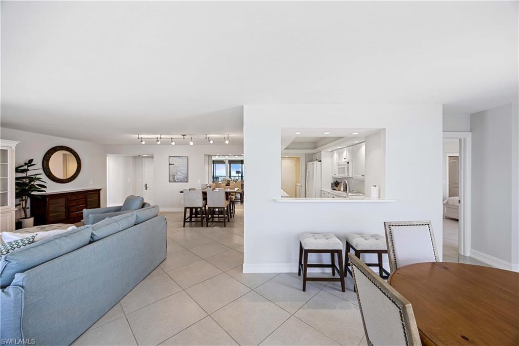 Living area with light tile patterned floors and recessed lighting