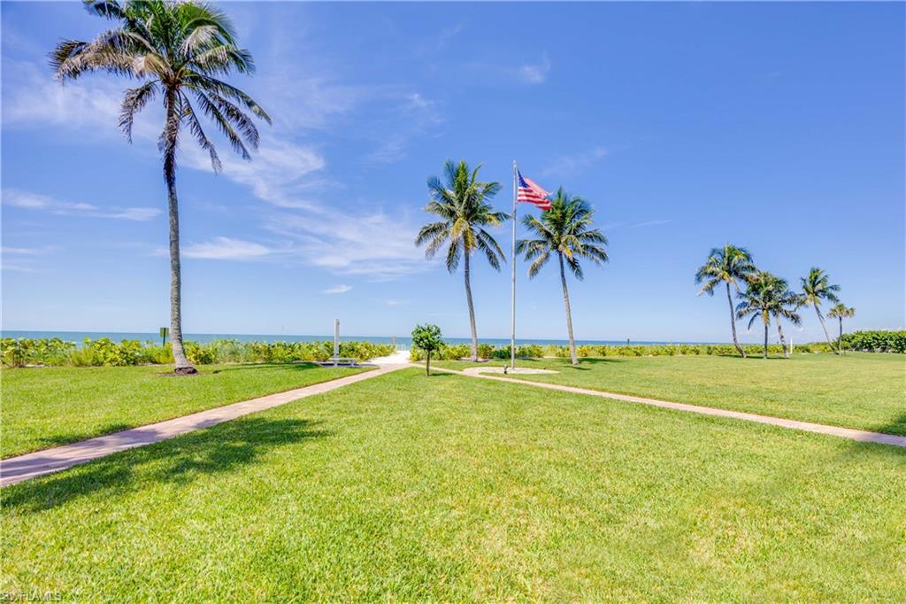 View of grassy yard with a water view