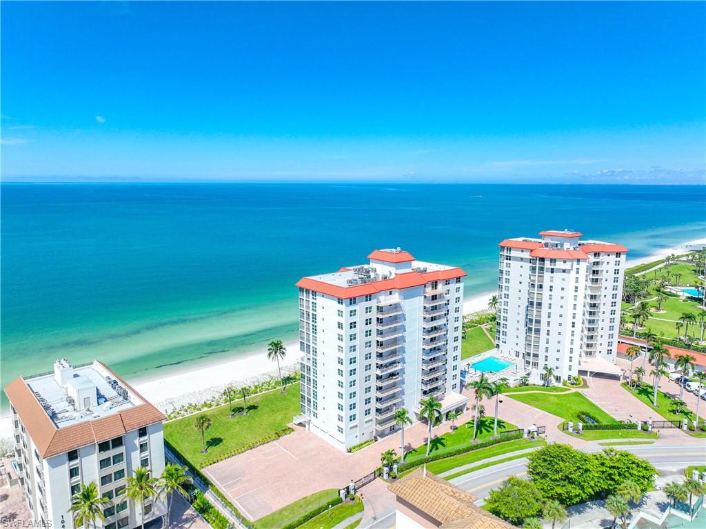 Bird's eye view of apartment complex and expansive beach