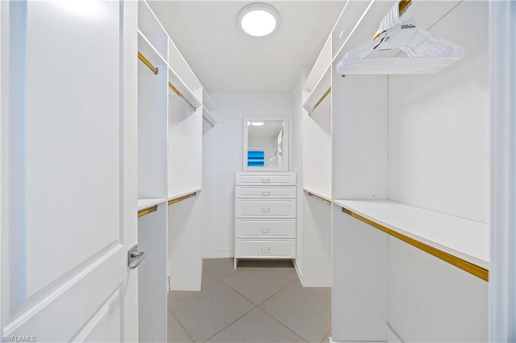 Walk in closet featuring light tile patterned floors