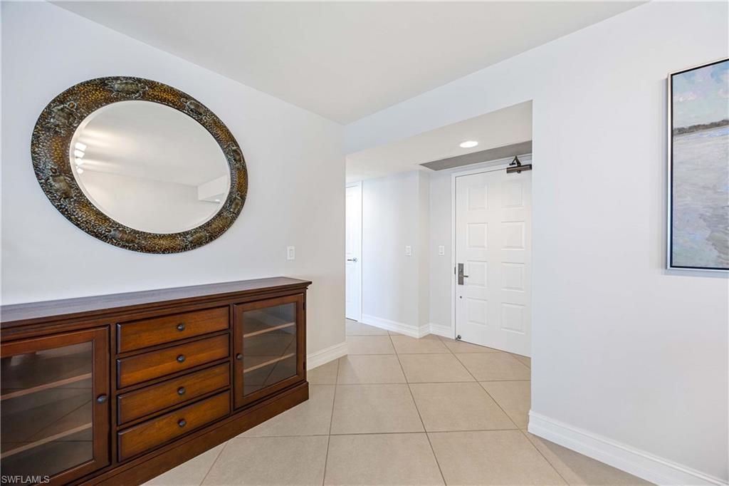 Corridor with light tile patterned floors and recessed lighting