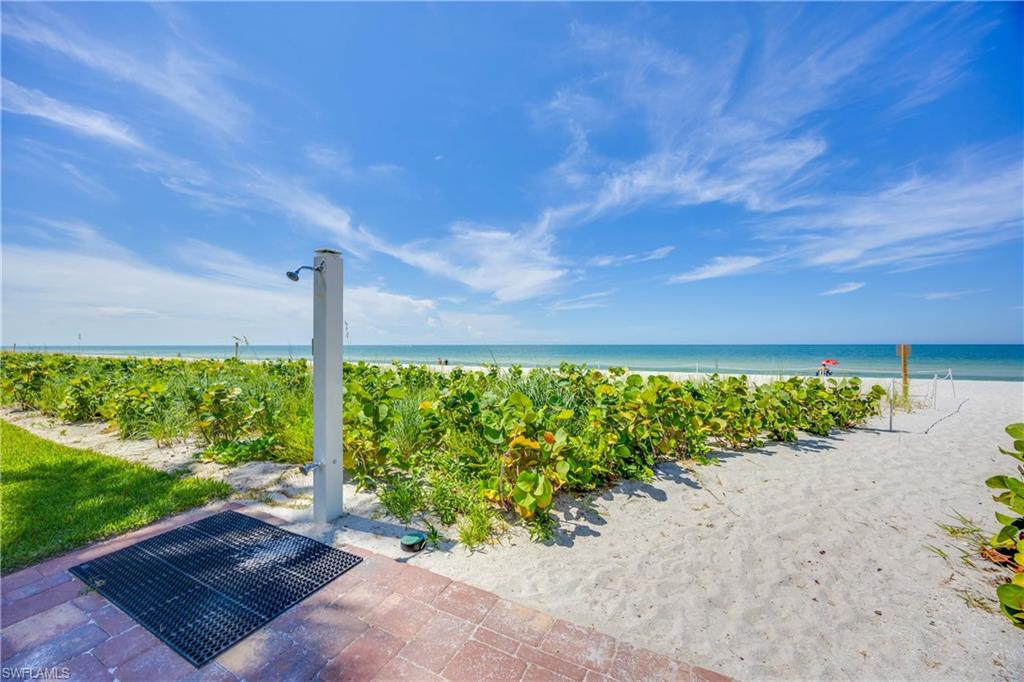 View of patio with view of water and beach