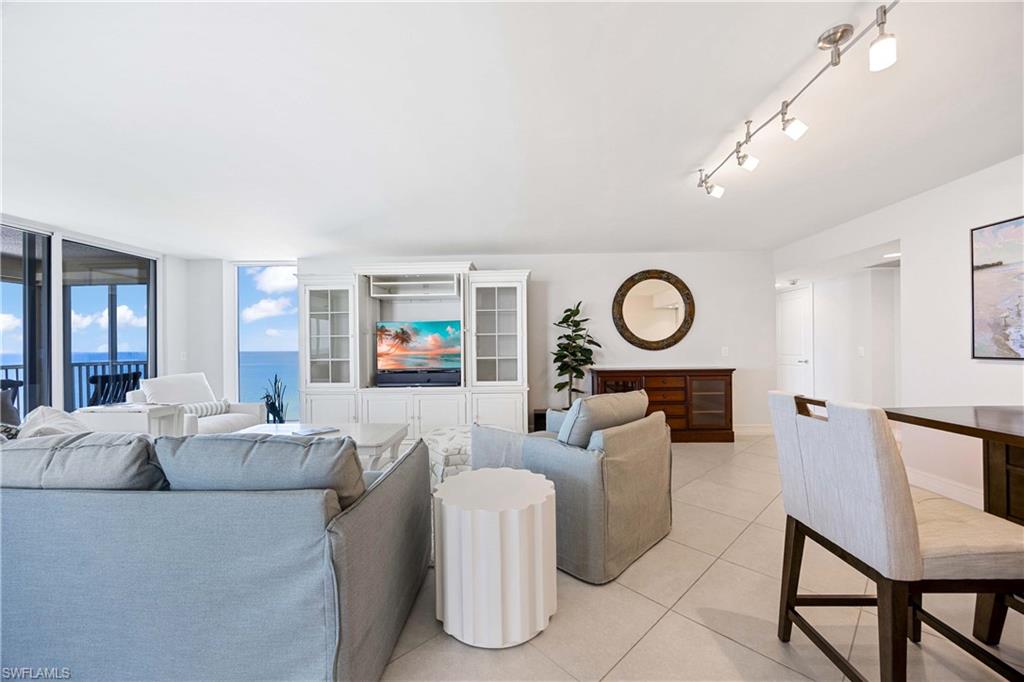 Living area with light tile patterned floors and baseboards