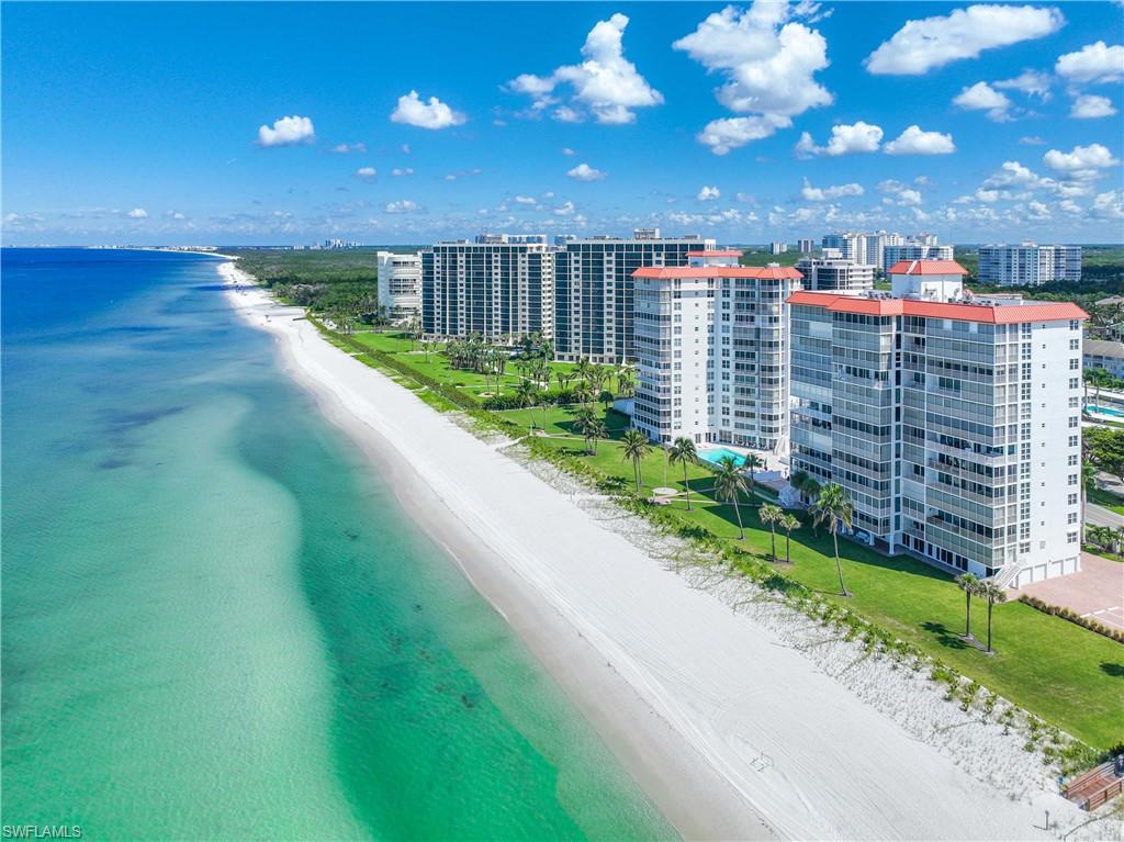 View of urban area featuring expansive beach and apartment complex