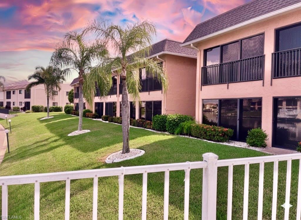 View of community with a balcony and a yard