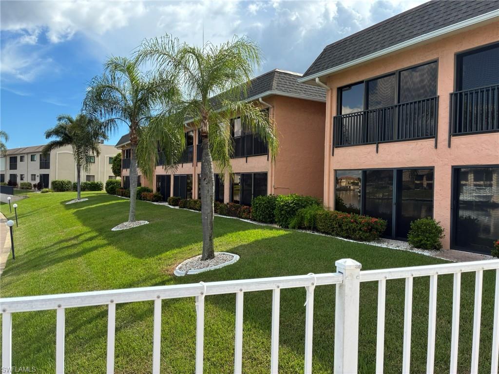 View of community with a balcony and a lawn