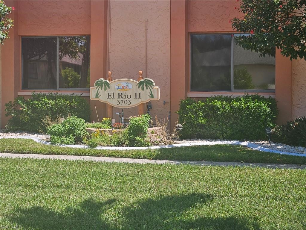 Community / neighborhood sign with a yard