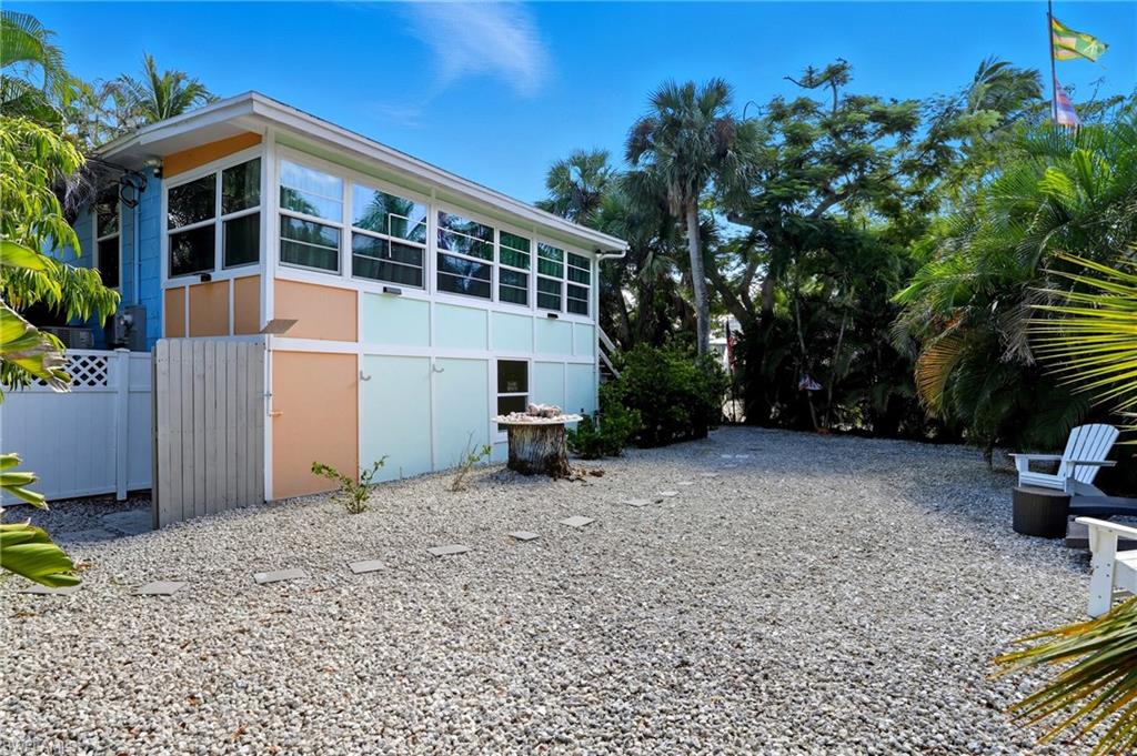 View of side of home featuring a sunroom - Virtually Edited Image