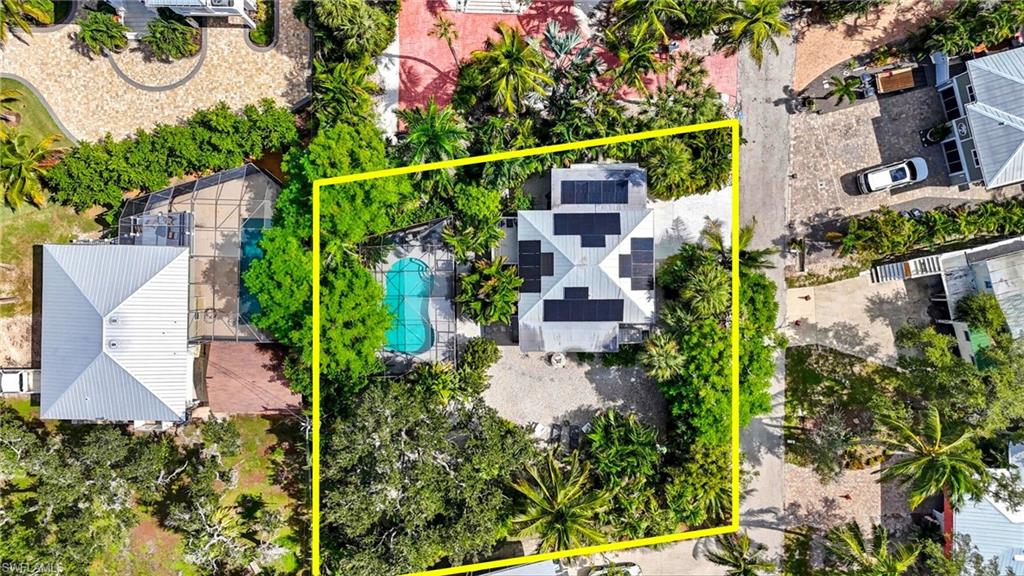 Aerial view of property, yard and a pool area - Virtually Edited Image