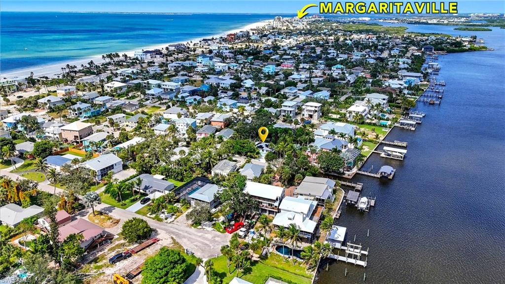 Aerial view of property and surrounding area featuring a large body of water and nearby suburban area - Virtually Edited Image