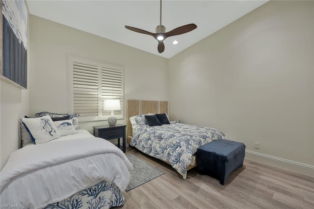 Bedroom with wood finished floors, a ceiling fan, and recessed lighting