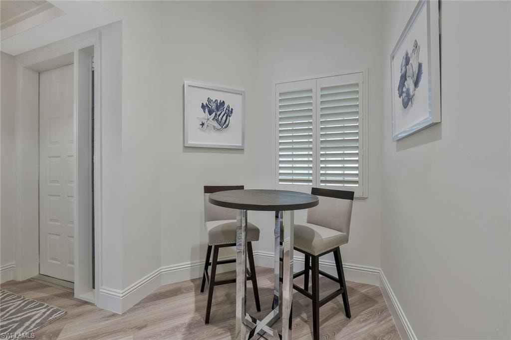 Dining area featuring light wood-type flooring and baseboards