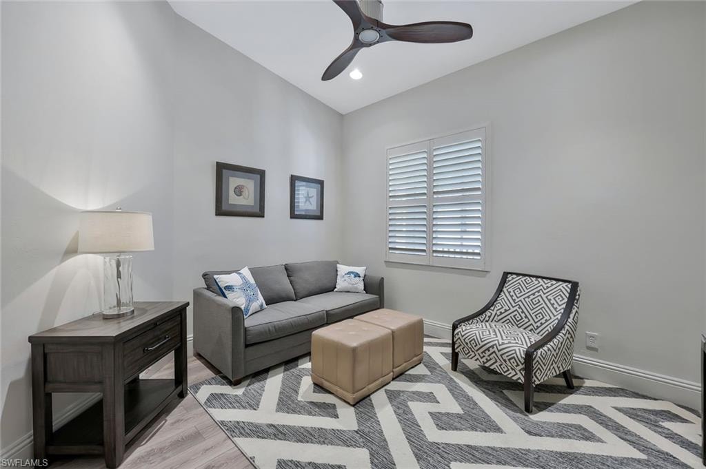 Living area featuring wood finished floors, ceiling fan, and recessed lighting