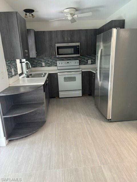Kitchen featuring tasteful backsplash, fridge, white stove, and stainless steel microwave