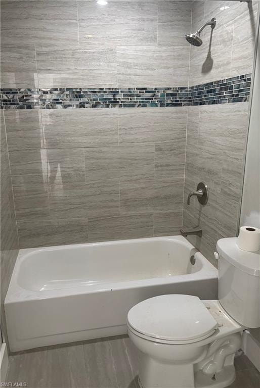 Full bath with shower / washtub combination and wood finished floors